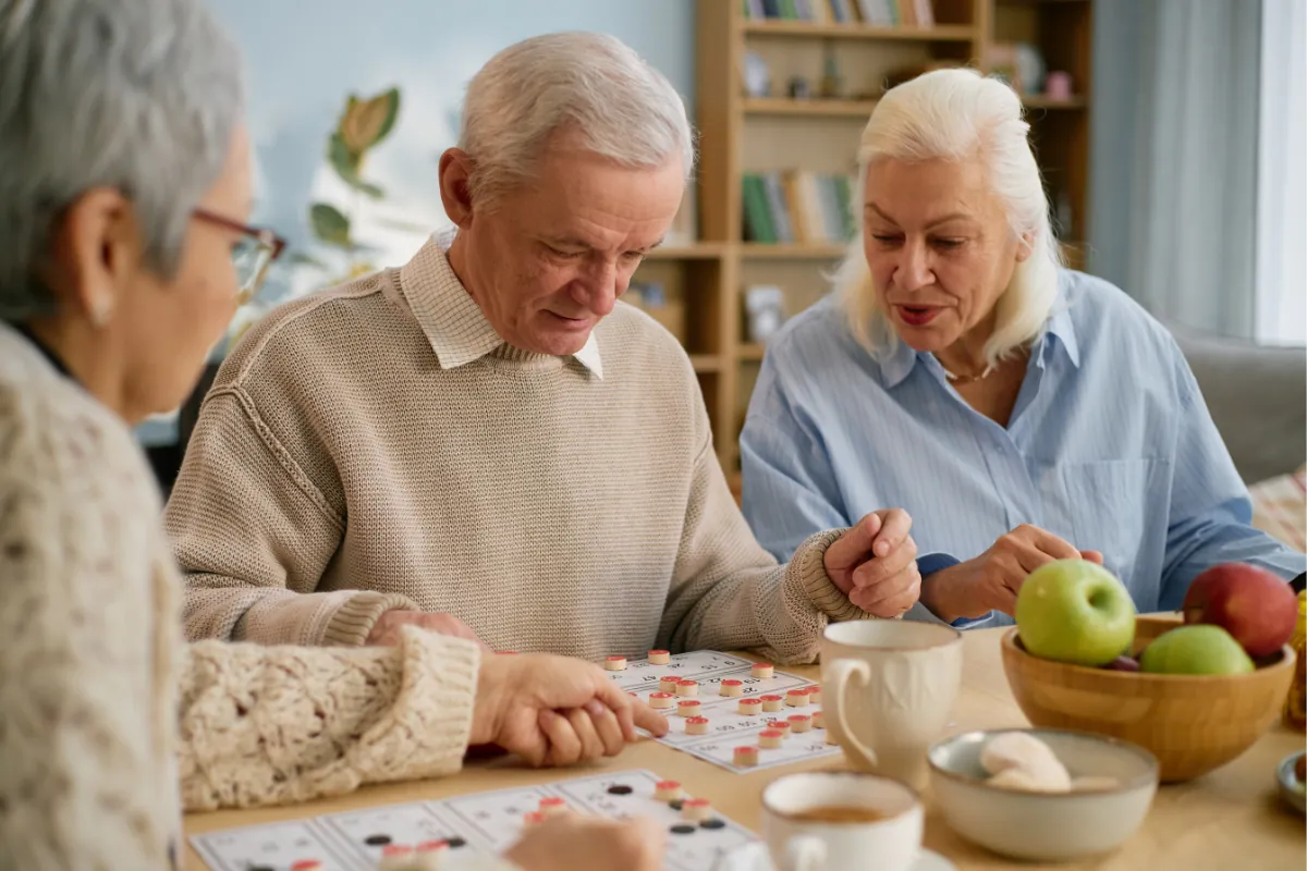 Residents enjoying a game together at an activity table