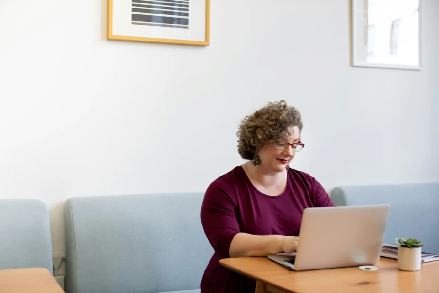 A village manager working at a laptop in a quiet office